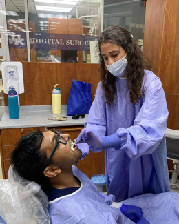 A PEPP-DMD student works with another student to create a denture mold.