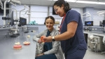 Dentistry Faculty giving instruction to dental student.