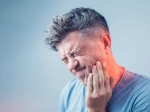 Man holding the side of his face due to jaw pain. 