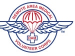 The image shows the Remote Area Medical (RAM) Volunteer Corps logo. It features a red parachute centered over a blue winged emblem, symbolizing aid delivery. The words “REMOTE AREA MEDICAL” and “VOLUNTEER CORPS” encircle the design in red text, with a cross containing “RAM” in the middle.