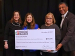 A group of four people stand smiling and holding an oversized check presented by the Kentucky Council on Postsecondary Education. The check, dated December 9, 2025, awards $35,976 to the University of Kentucky College of Dentistry for Dental Assistant/EDDA training, with UK HealthCare listed as the healthcare partner.